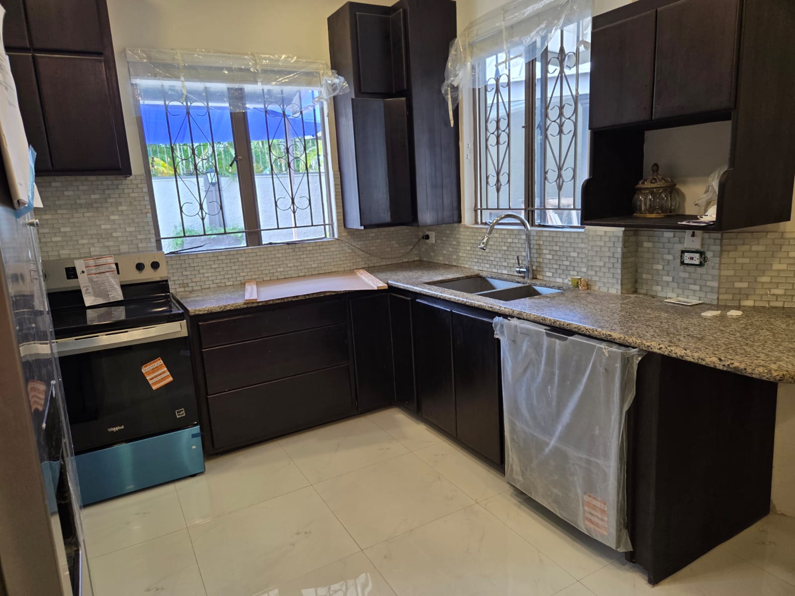 Kitchen with dark wood cabinetry and granite counters